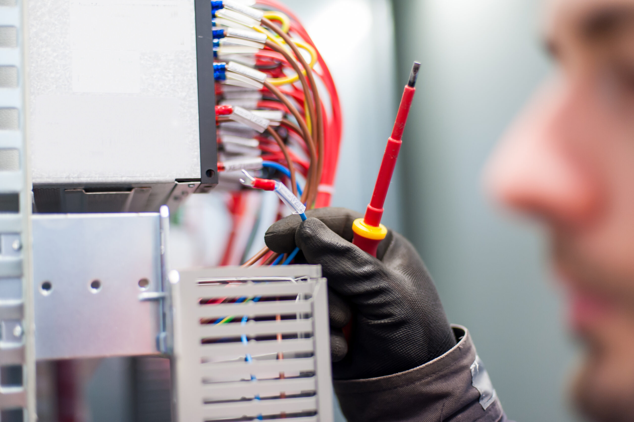 Closeup photo of S Clark electrician engineer working with electric cable wires of fuse box