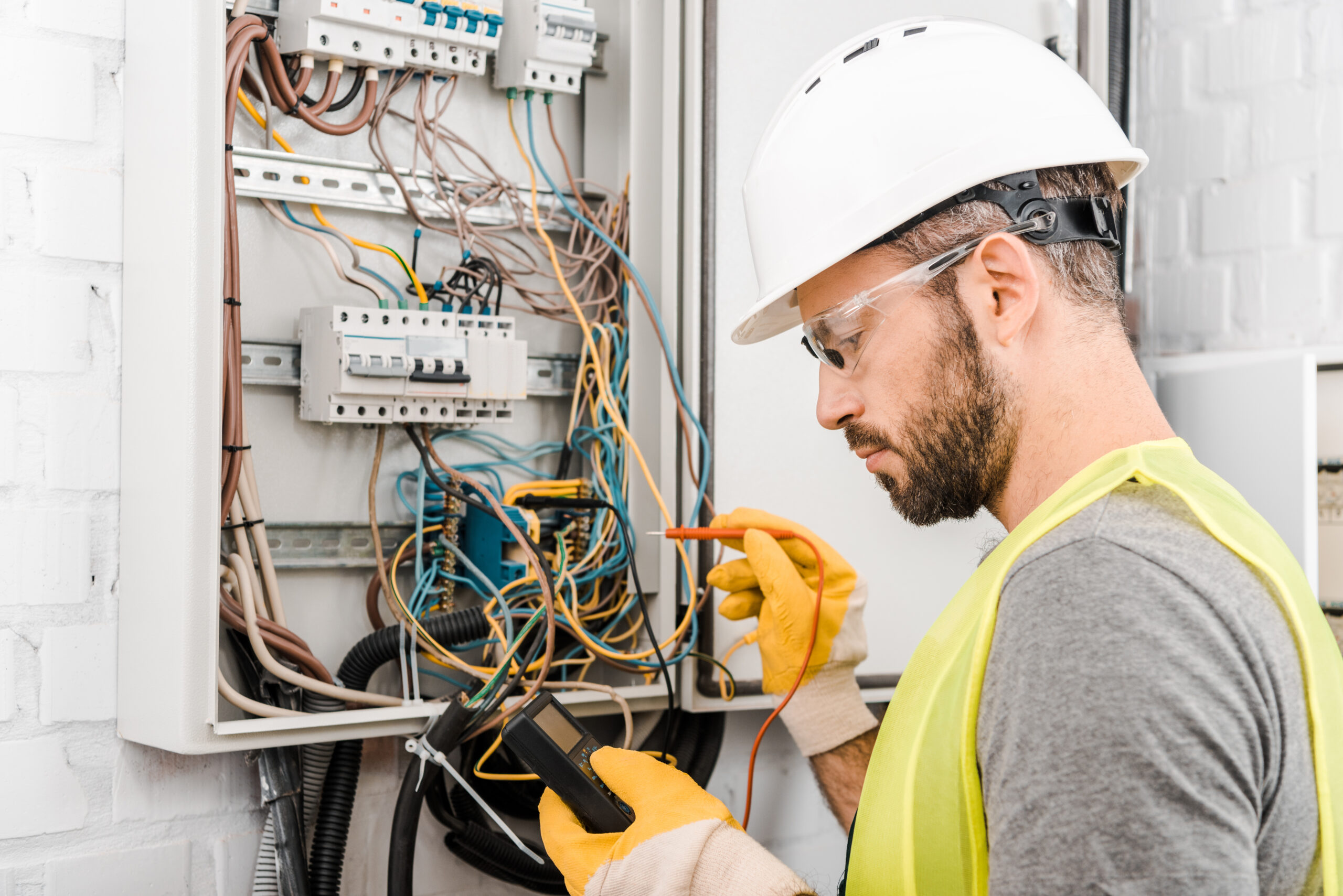 S. Clark electrician checking electrical box