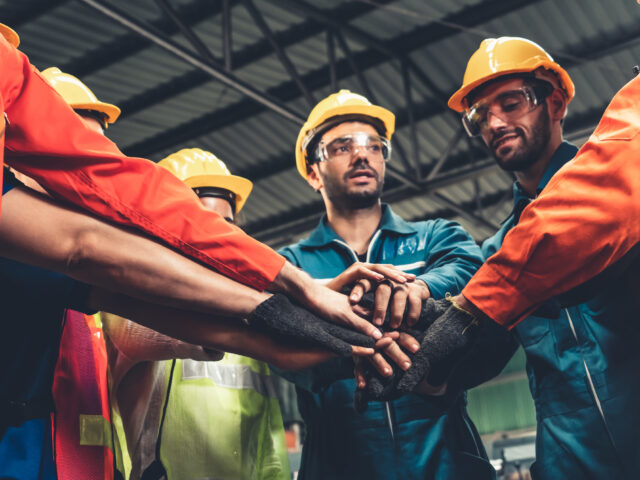 S. Clark electric workers standing together showing teamwork