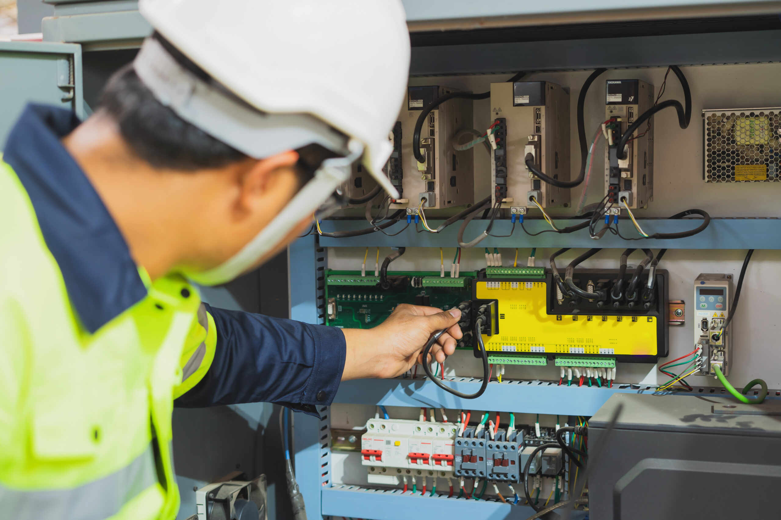 Image of an S Clark electrician doing work on a power box